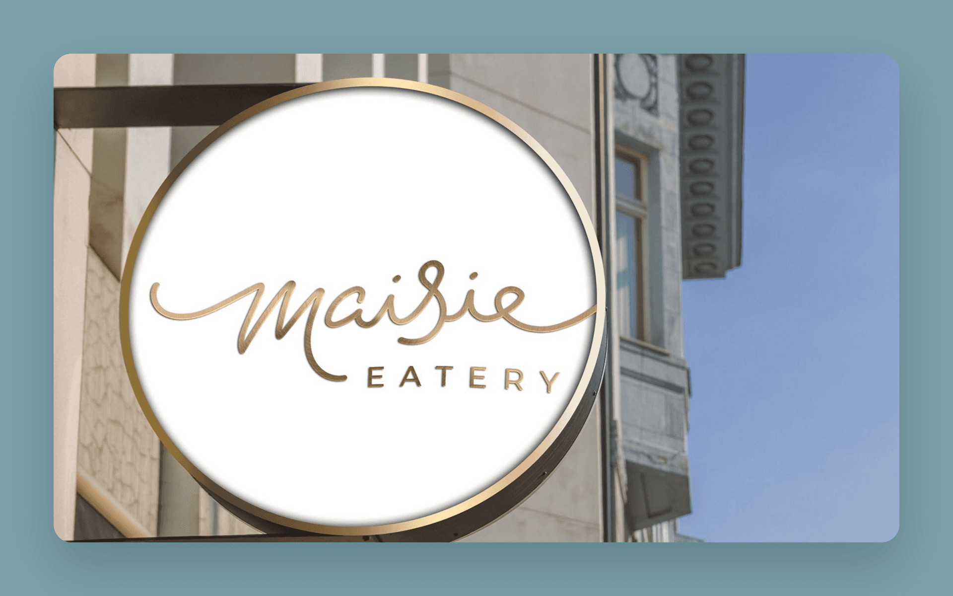 The gold Maisie Eatery blade sign outside the Sam Centre